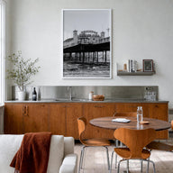 Brighton black & white photo poster of England, UK – vertical wall art in white wood frame, hanging on wall