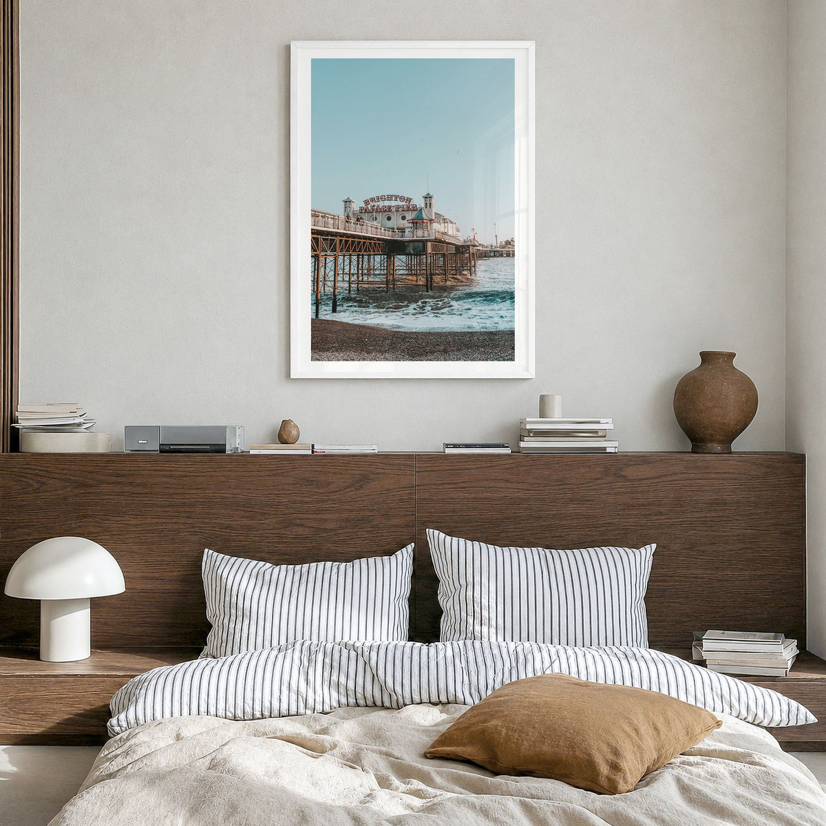 Brighton Photo Poster in a white wood frame, hanging in a bedroom, white border