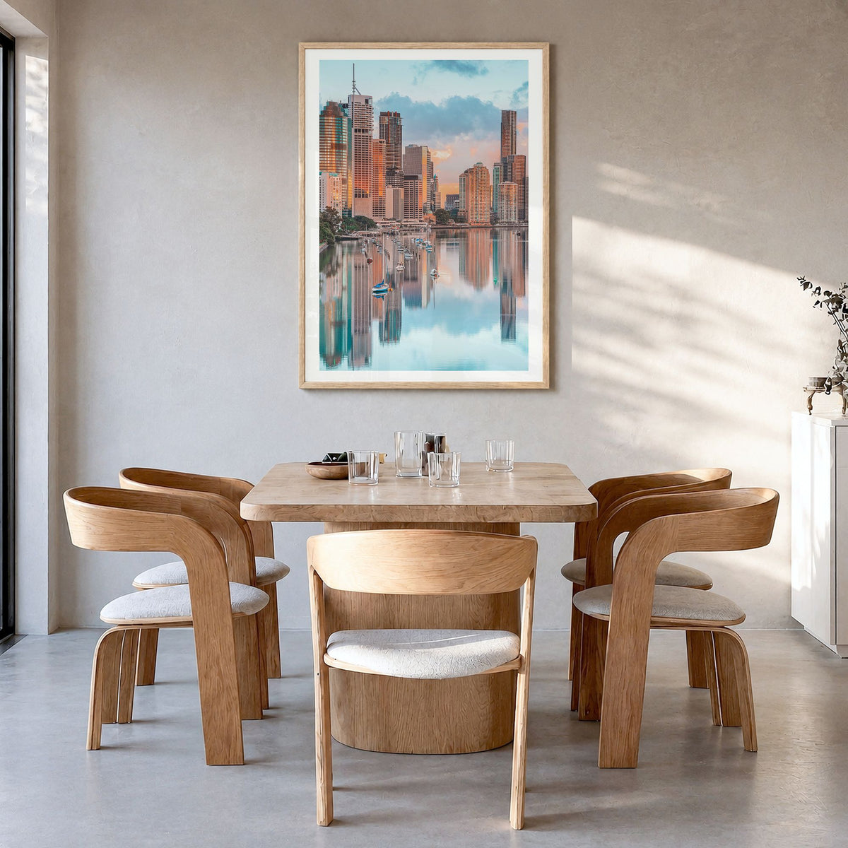 Brisbane Photo Poster in a natural wood frame, hanging in a dining room, white border