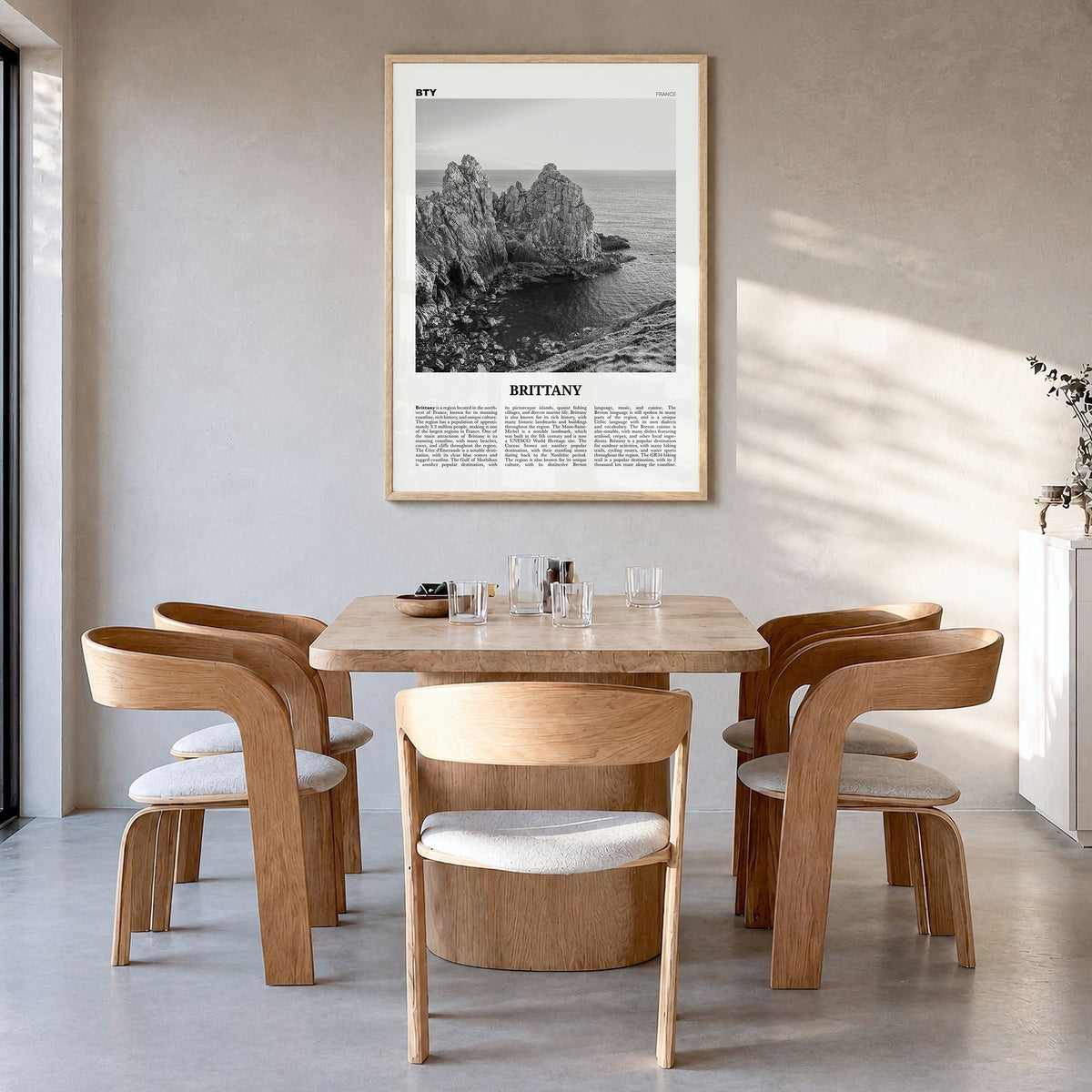 Brittany Newspaper Poster in a natural wood frame, hanging in a dining room