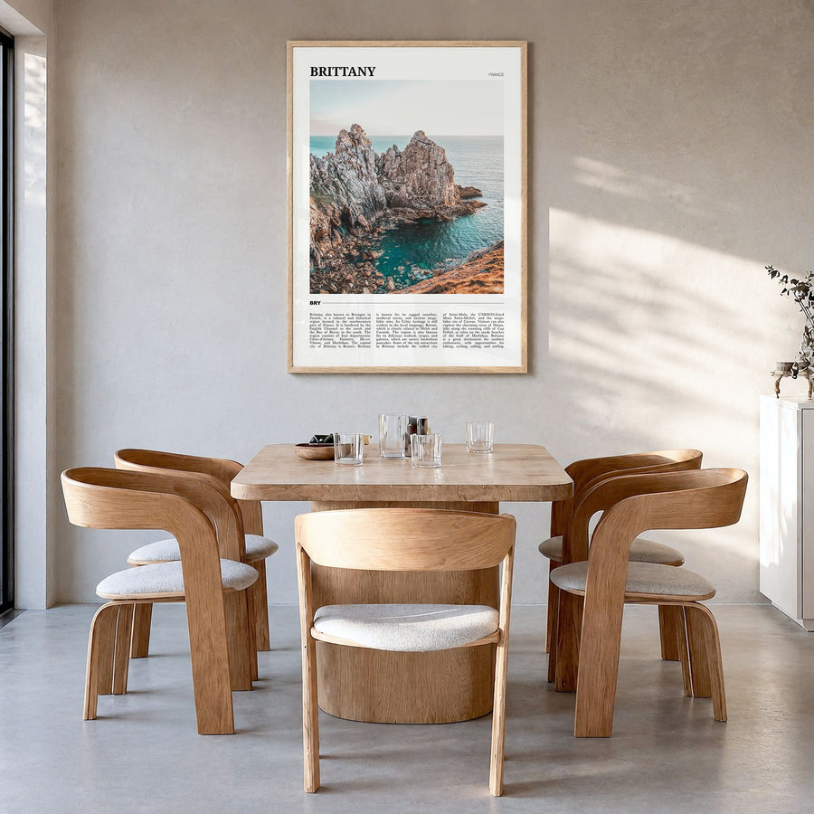 Brittany Travel Poster in a natural wood frame, hanging in a dining room