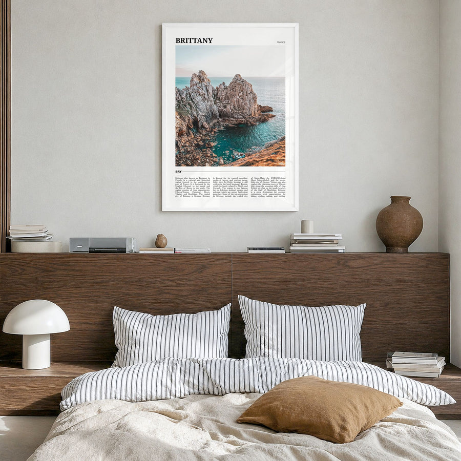 Brittany Travel Poster in a white wood frame, hanging in a bedroom