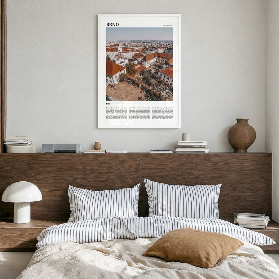 Brno Travel Poster in a white wood frame, hanging in a bedroom