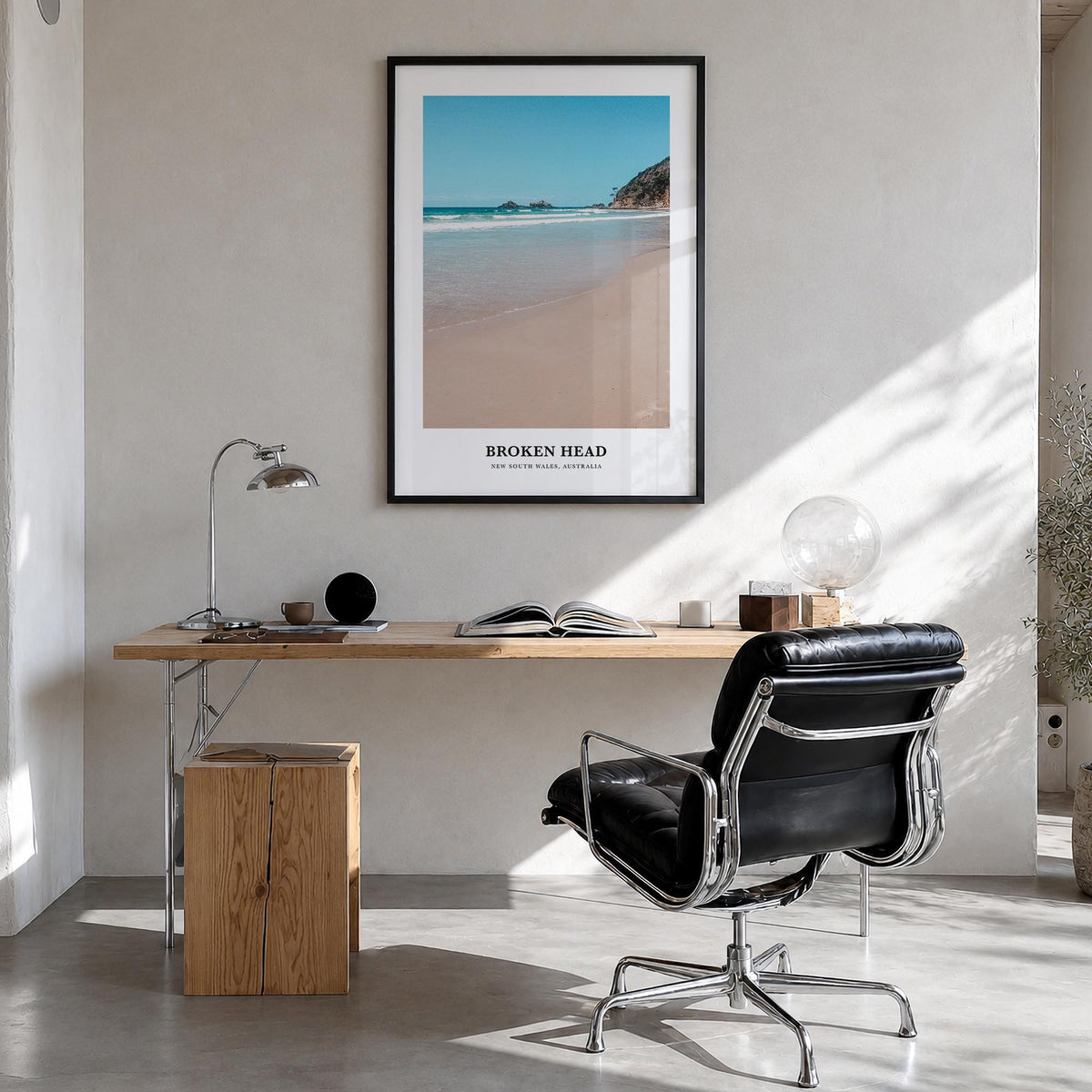 Broken Head colorful classic poster of Australia – vertical wall art in black wood frame, hanging on wall