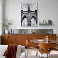 Brooklyn Bridge black & white photo poster of New York City, New York – vertical wall art in white wood frame, hanging on wal