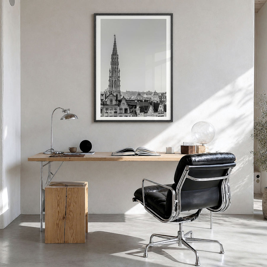 Brussels Photo Poster in a black wood frame, hanging in a bright home office, white border