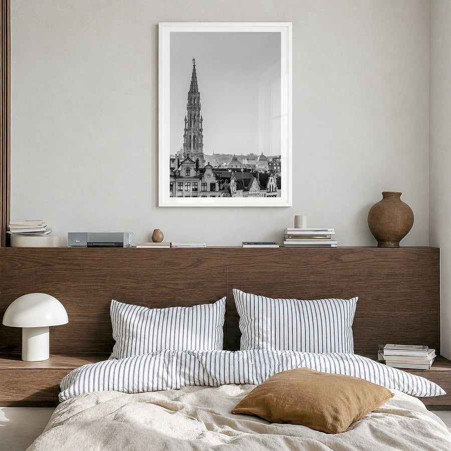 Brussels Photo Poster in a white wood frame, hanging in a bedroom, white border