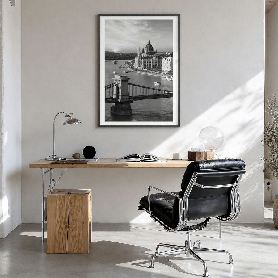 Budapest Photo Poster in a black wood frame, hanging in a bright home office, white border