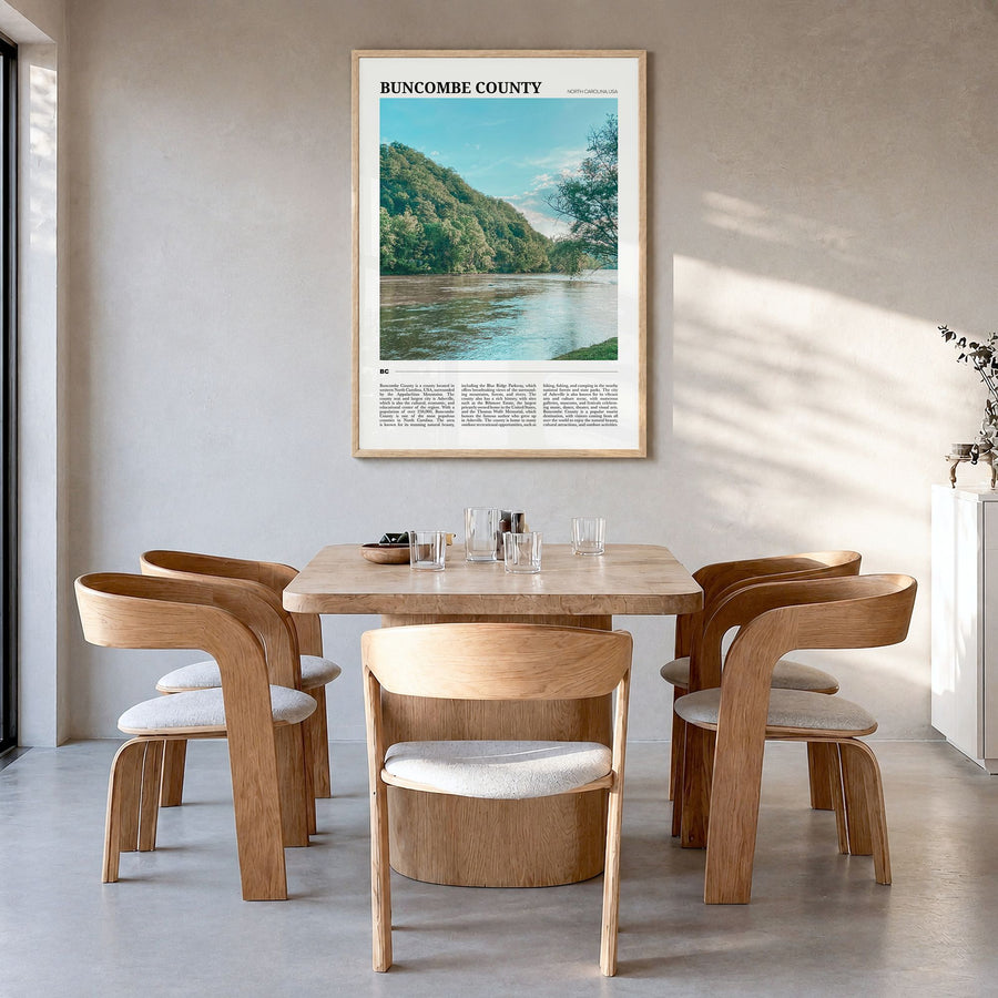 Buncombe County Travel Poster in a natural wood frame, hanging in a dining room