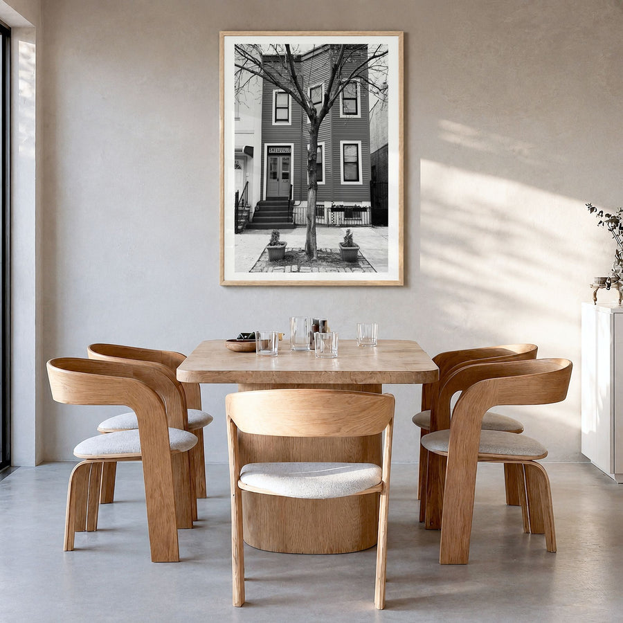 Bushwick Photo Poster in a natural wood frame, hanging in a dining room, white border