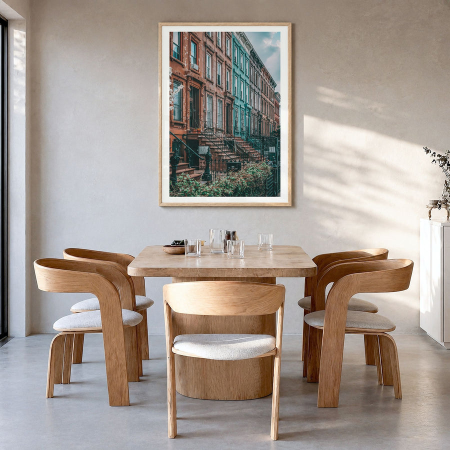 Bushwick Photo Poster in a natural wood frame, hanging in a dining room, white border
