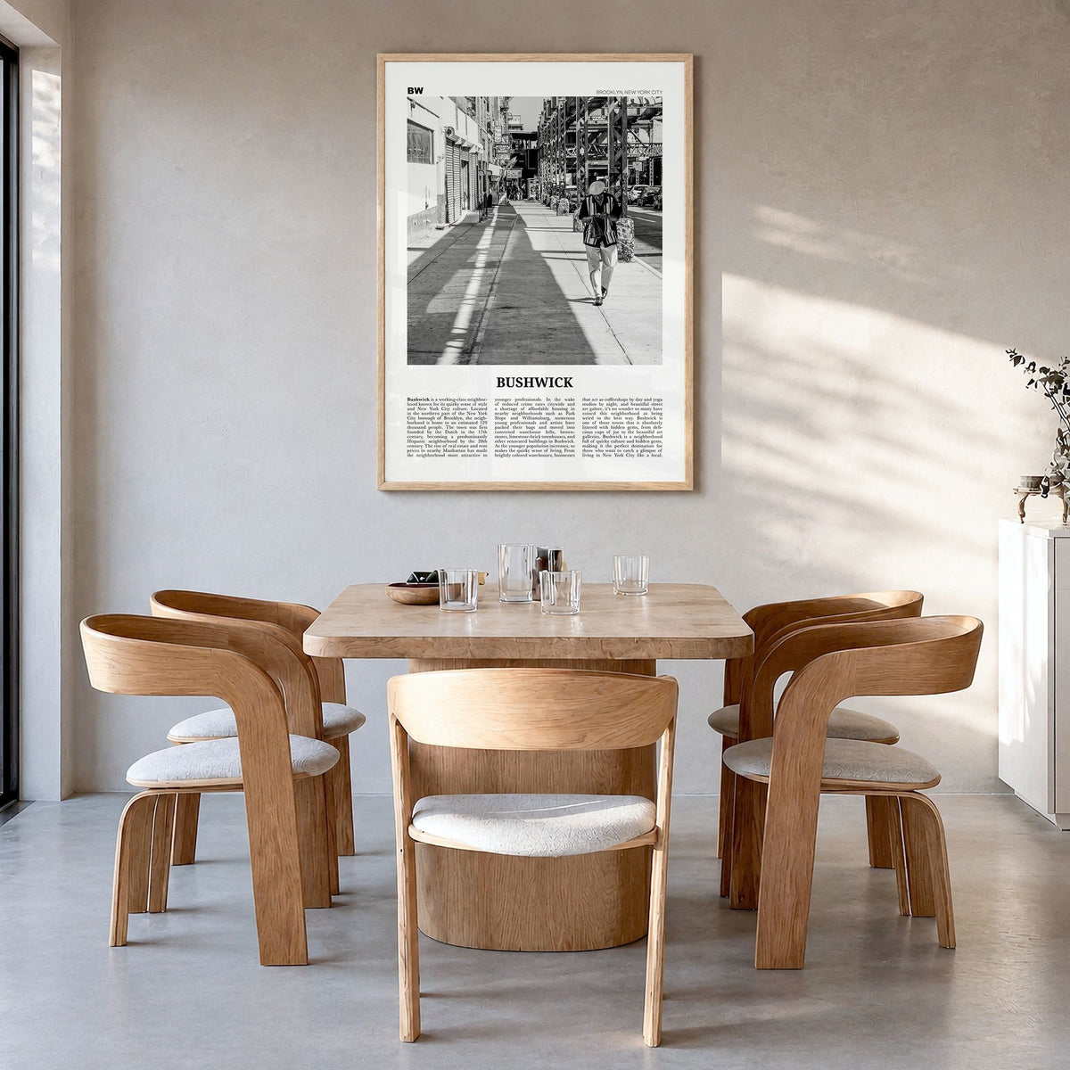 Bushwick Newspaper Poster in a natural wood frame, hanging in a dining room
