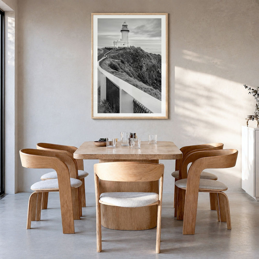 Byron Bay Photo Poster in a natural wood frame, hanging in a dining room, white border