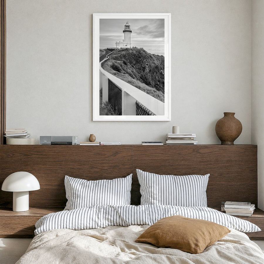 Byron Bay Photo Poster in a white wood frame, hanging in a bedroom, white border