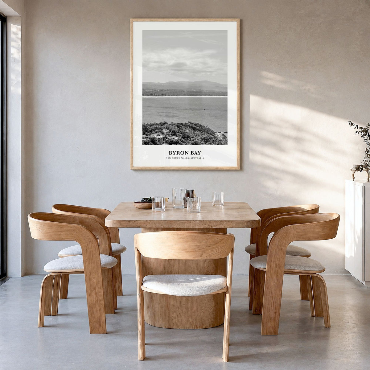 Byron Bay Classic No 2 Poster in a natural wood frame, hanging in a dining room