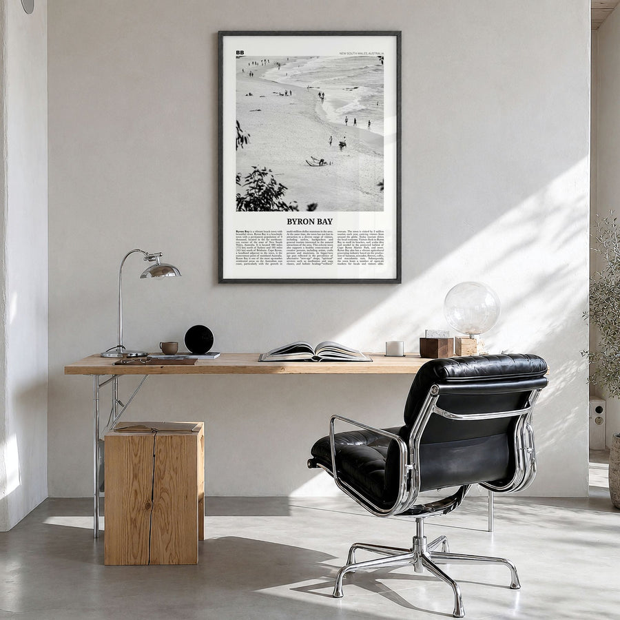 Byron Bay Newspaper No 1 Poster in a black wood frame, hanging in a bright home office