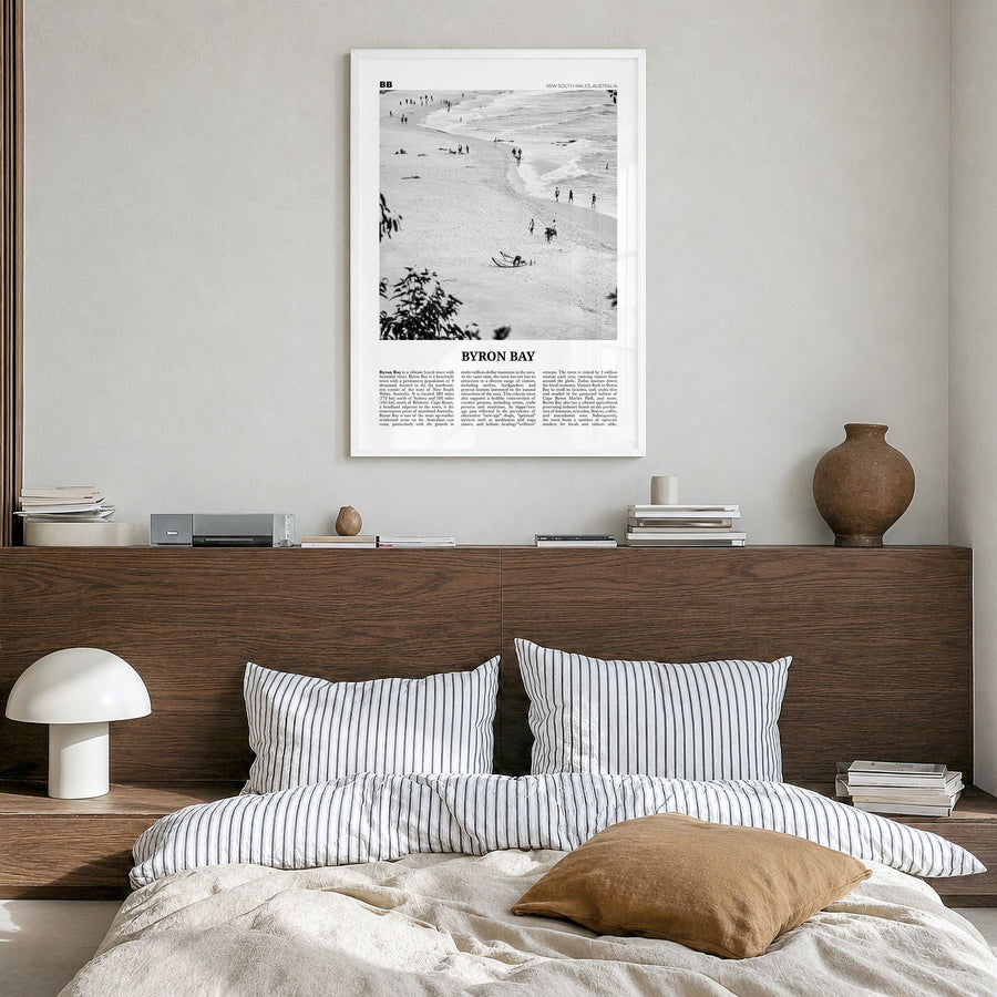Byron Bay Newspaper No 1 Poster in a white wood frame, hanging in a bedroom