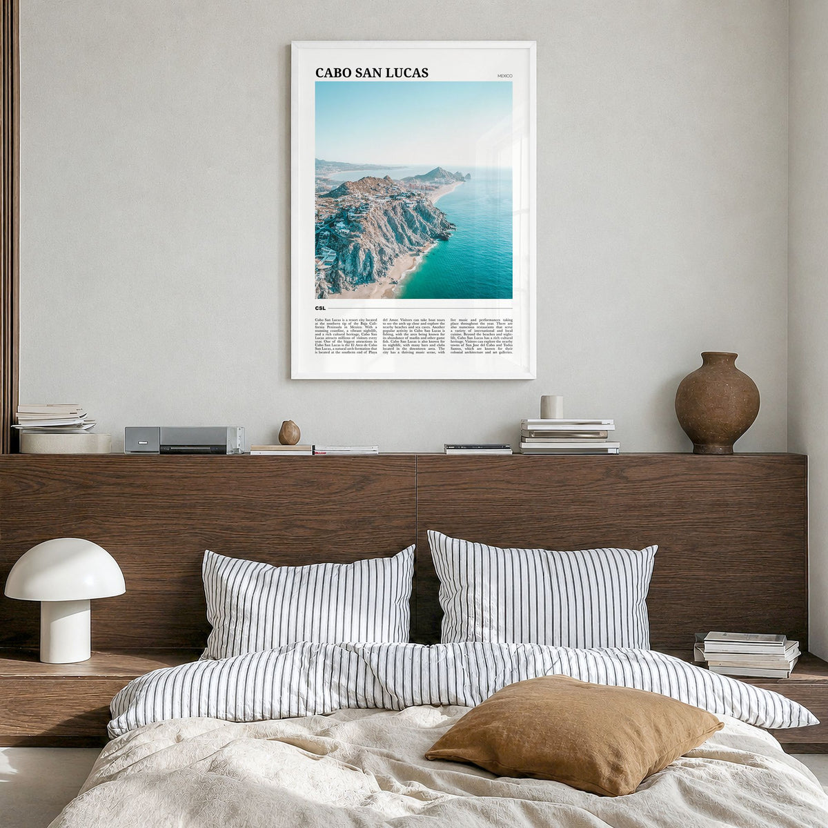 Cabo San Lucas Travel Poster in a white wood frame, hanging in a bedroom