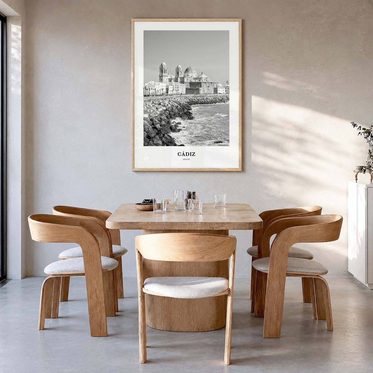 Cádiz Classic Poster in a natural wood frame, hanging in a dining room