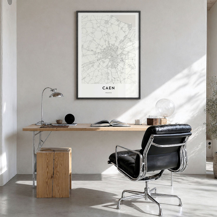 Caen Map Poster in a black wood frame, hanging in a bright home office
