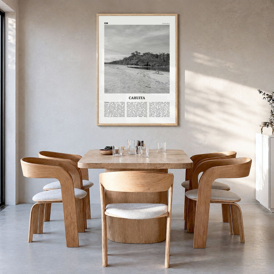 Cahuita Newspaper Poster in a natural wood frame, hanging in a dining room