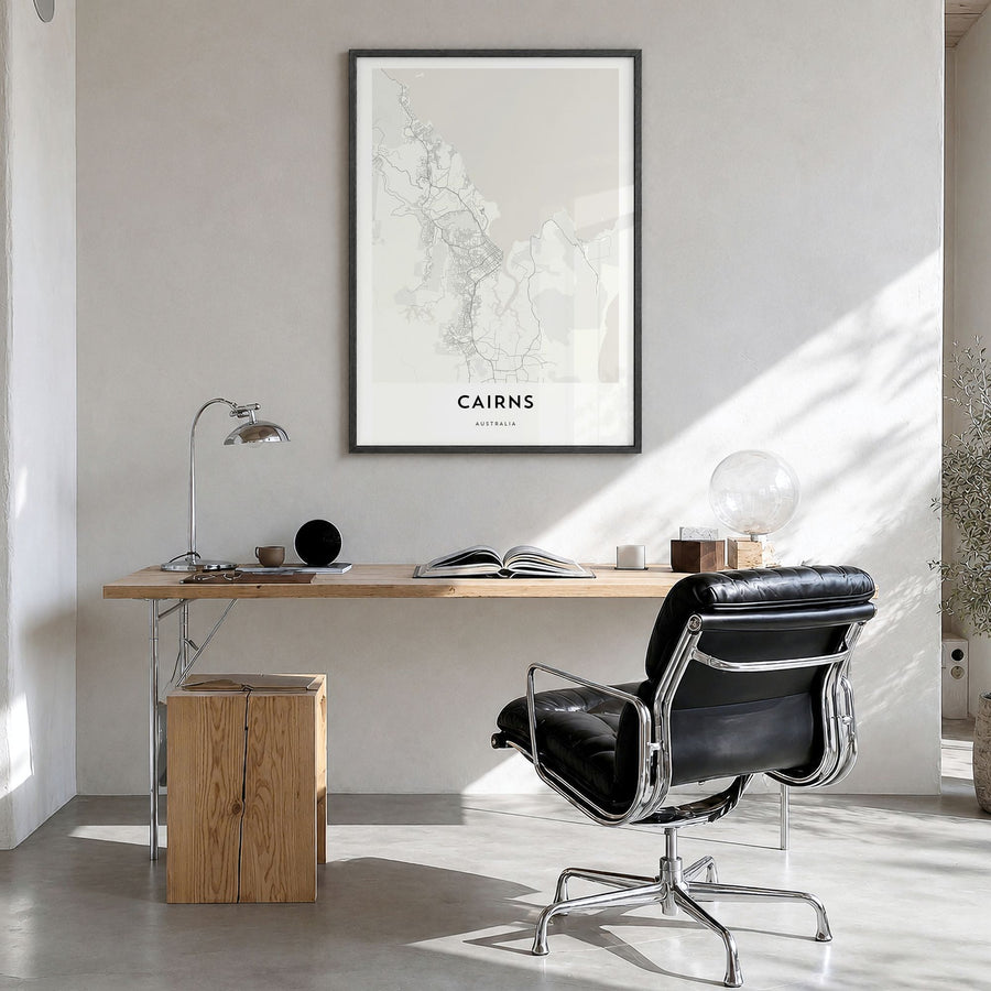 Cairns Map Poster in a black wood frame, hanging in a bright home office