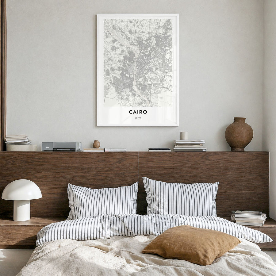 Cairo Map Poster in a white wood frame, hanging in a bedroom