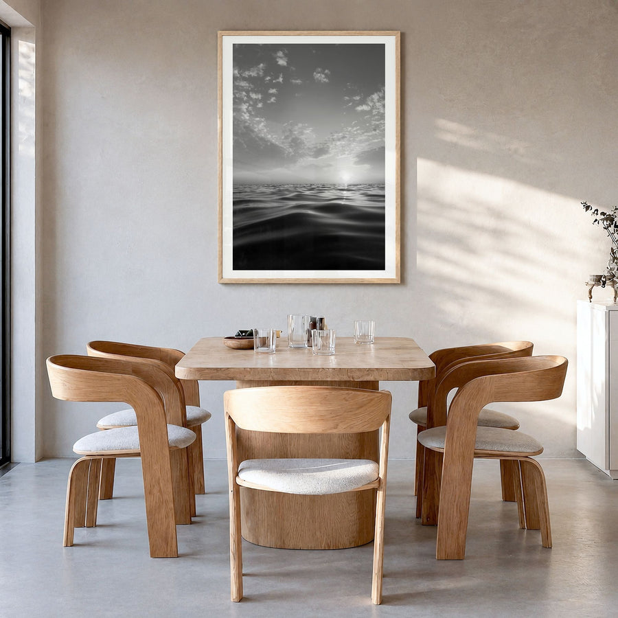 Calm Sunset Photo Poster in a natural wood frame, hanging in a dining room, white border
