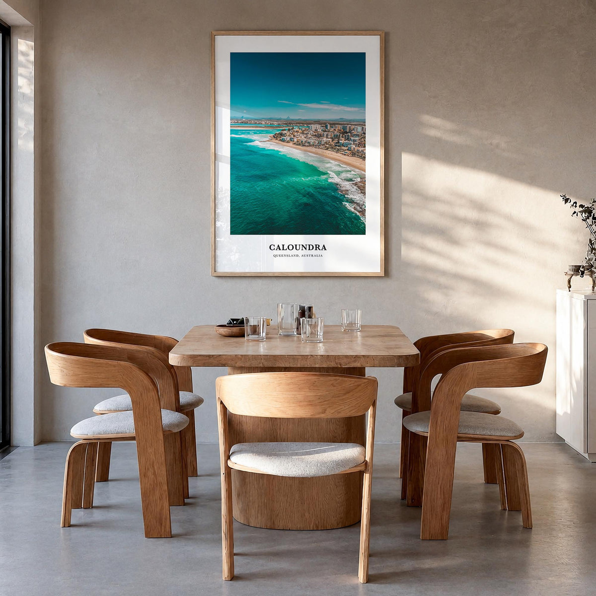 Caloundra colorful classic poster of Australia – vertical wall art in natural wood frame, hanging on wall