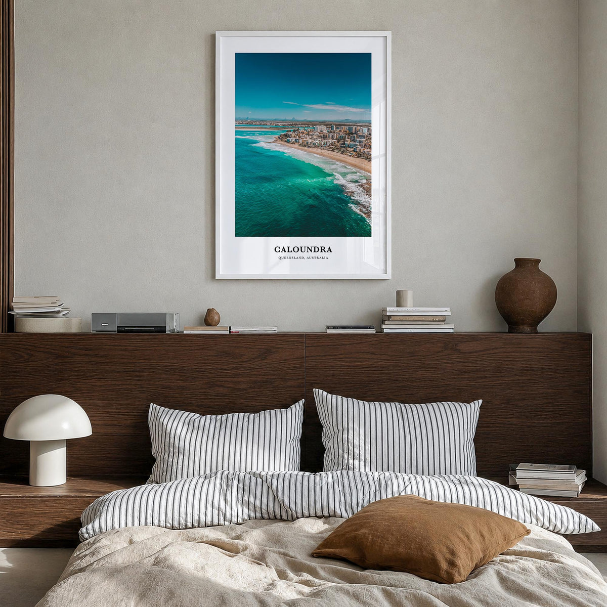 Caloundra colorful classic poster of Australia – vertical wall art in white wood frame, hanging on wall