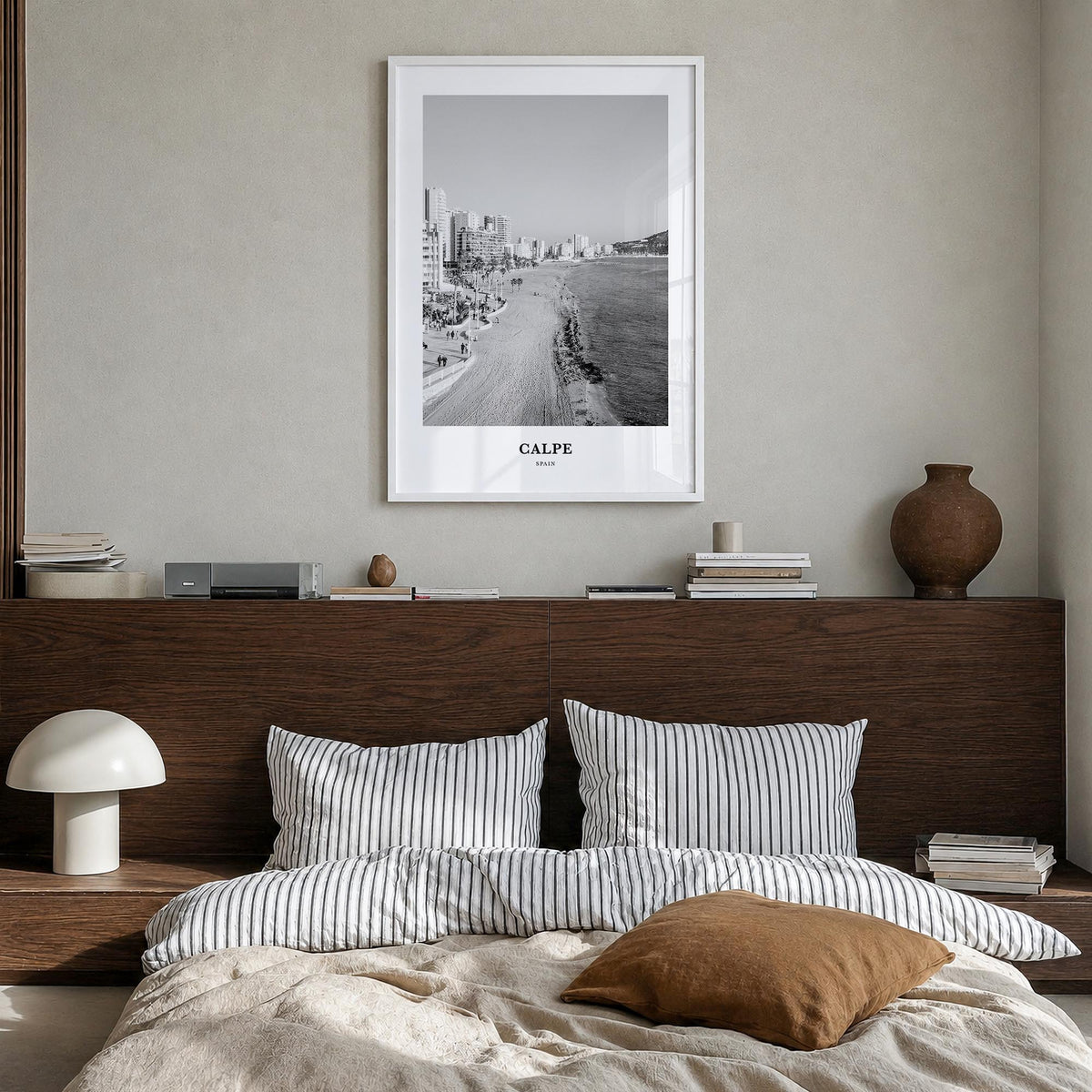 Calpe black & white classic poster of Spain – vertical wall art in white wood frame, hanging on wall