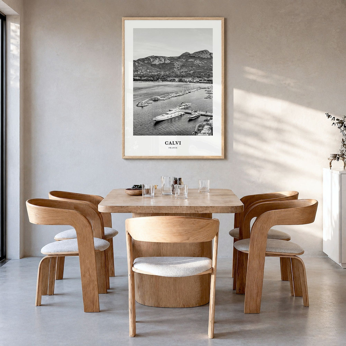 Calvi Classic Poster in a natural wood frame, hanging in a dining room