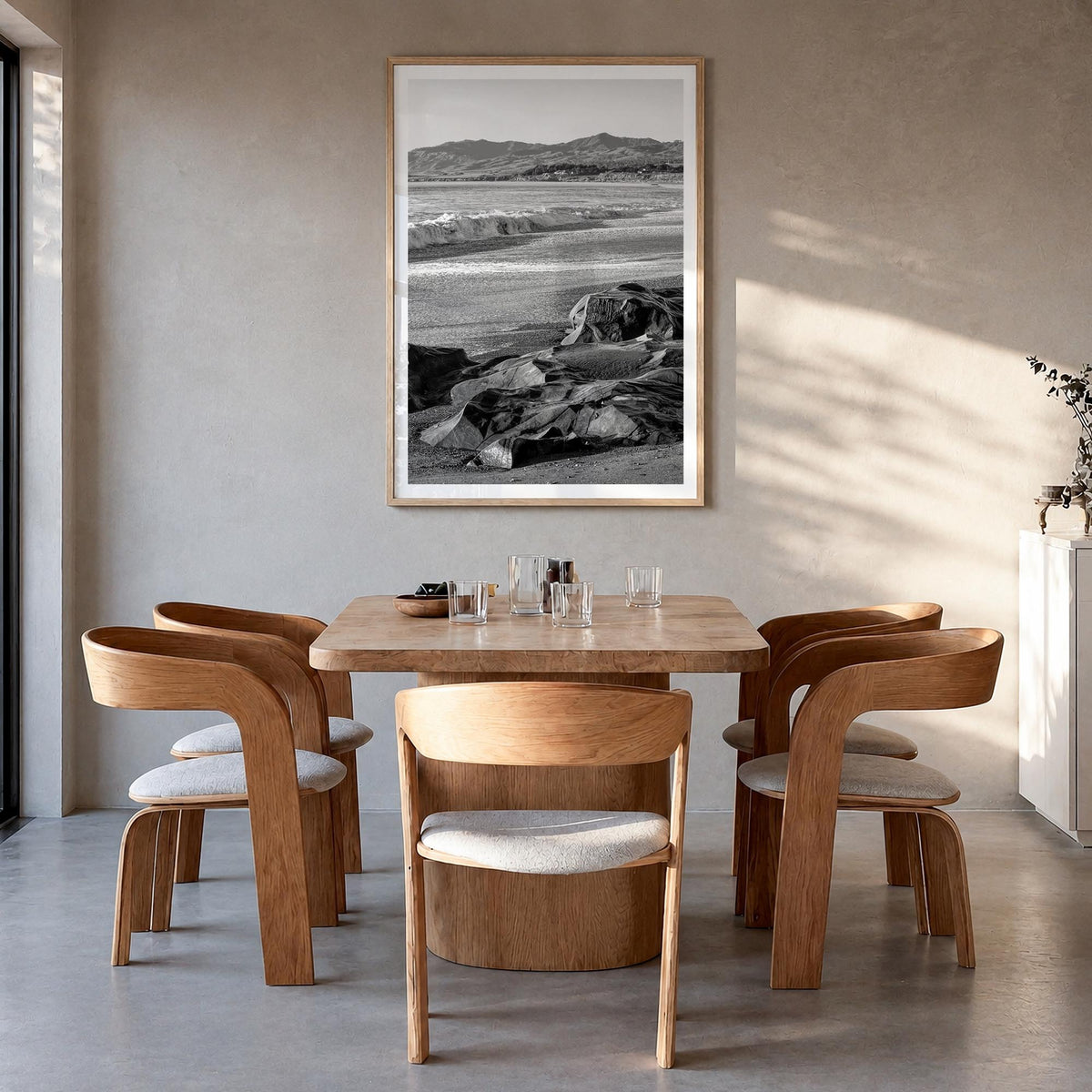 Cambria black & white photo poster of California, USA – vertical wall art in natural wood frame with white border, hanging on