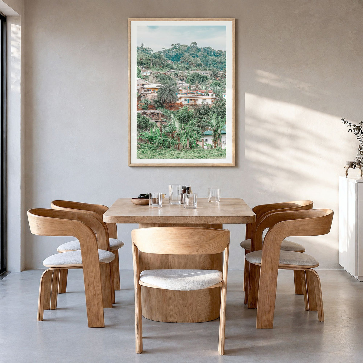Cameroon Photo Poster in a natural wood frame, hanging in a dining room, white border