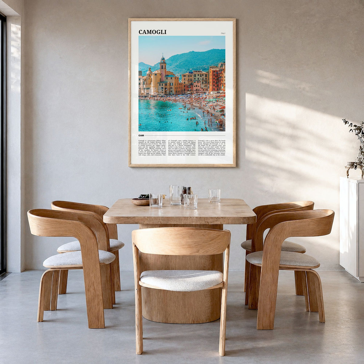 Camogli Travel Poster in a natural wood frame, hanging in a dining room