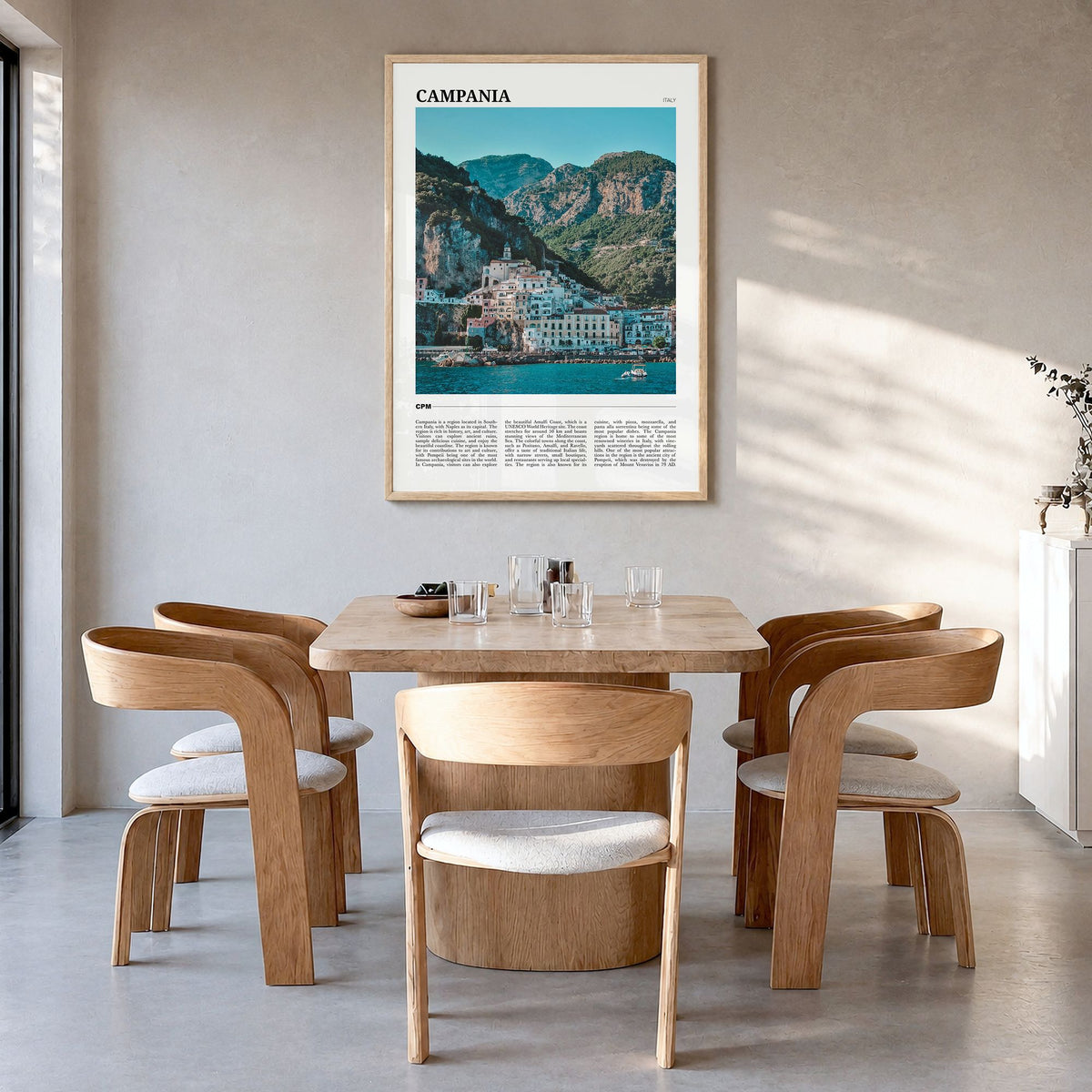 Campania Travel Poster in a natural wood frame, hanging in a dining room
