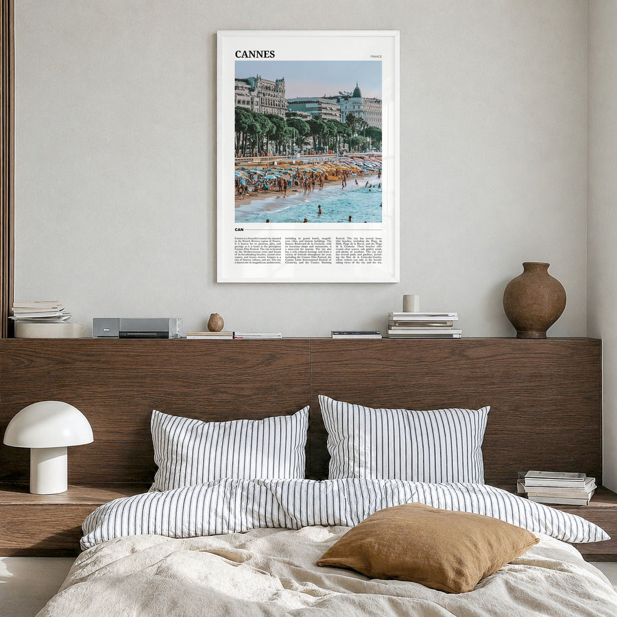 Cannes Travel Poster in a white wood frame, hanging in a bedroom