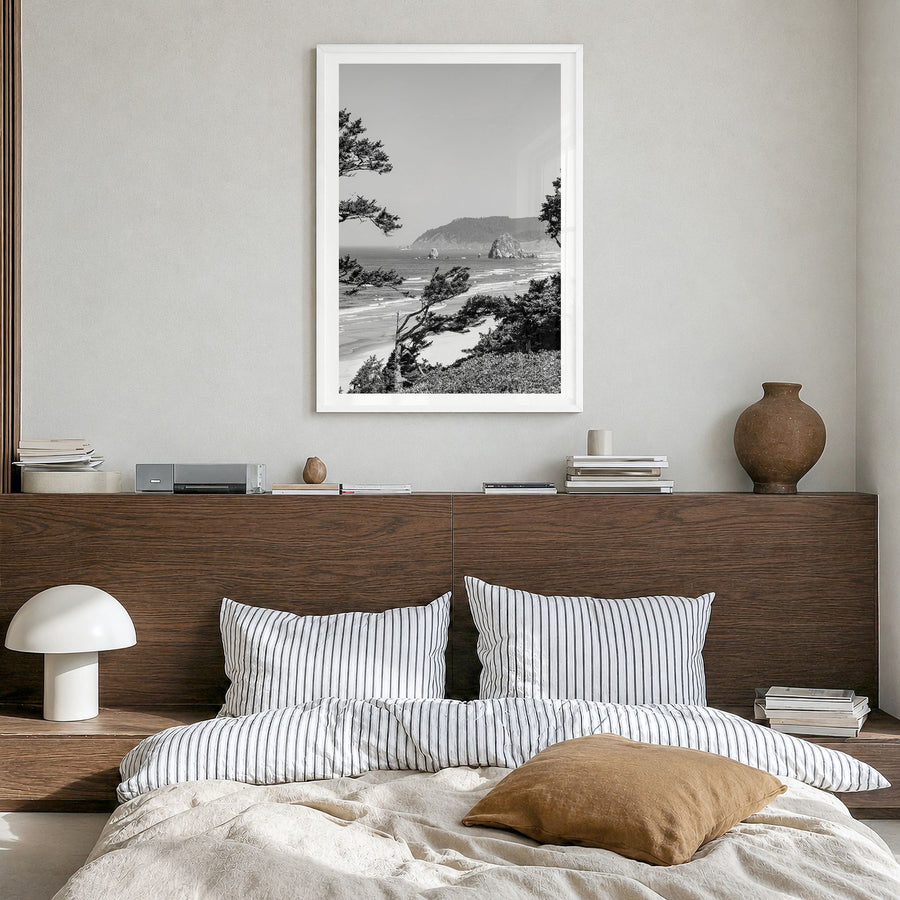 Cannon Beach Photo Poster in a white wood frame, hanging in a bedroom, white border