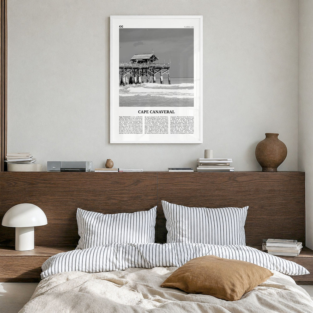 Cape Canaveral Newspaper Poster in a white wood frame, hanging in a bedroom