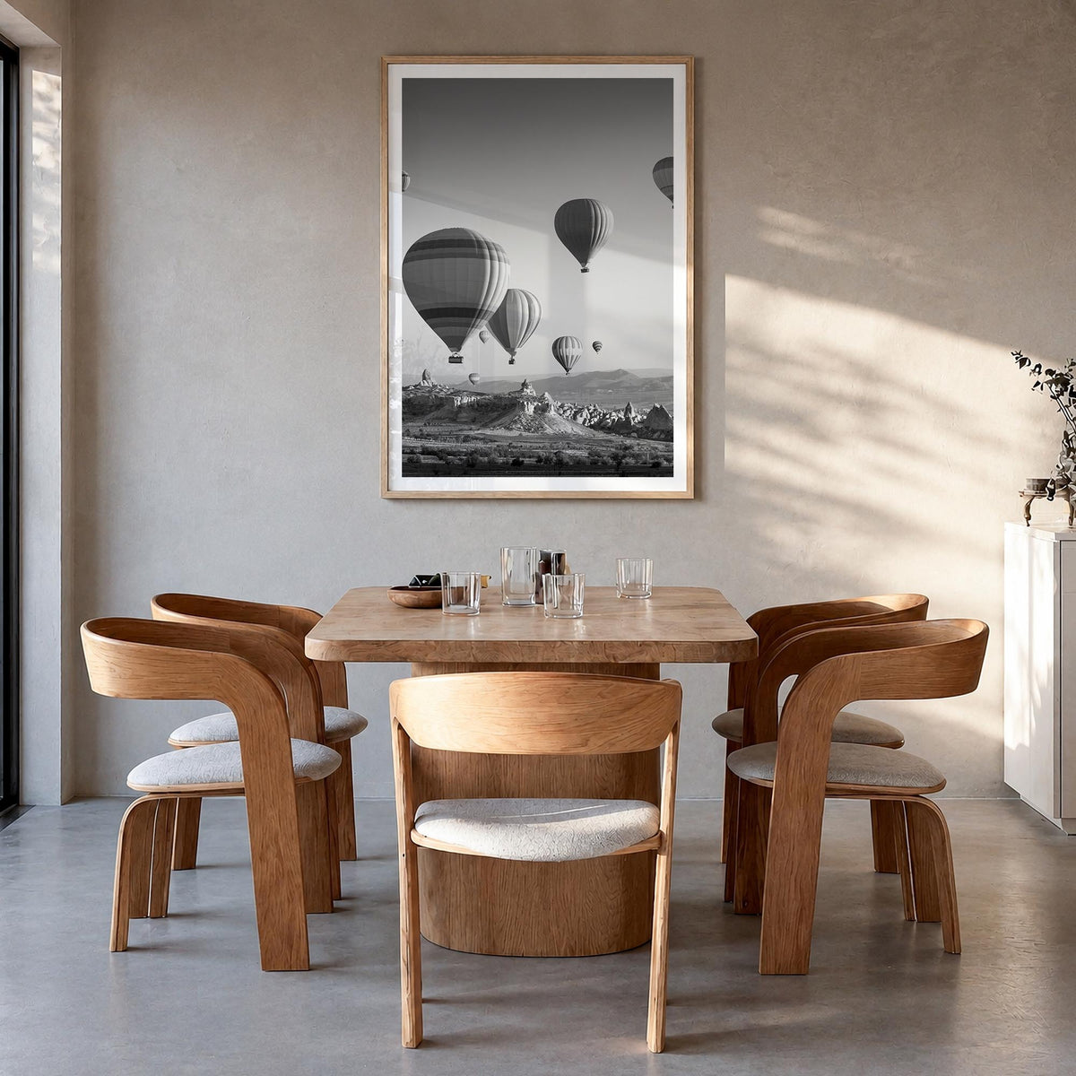 Cappadocia black & white photo poster of Türkiye – vertical wall art in natural wood frame with white border, hanging on wall