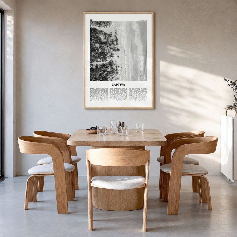 Captiva Newspaper No 1 Poster in a natural wood frame, hanging in a dining room