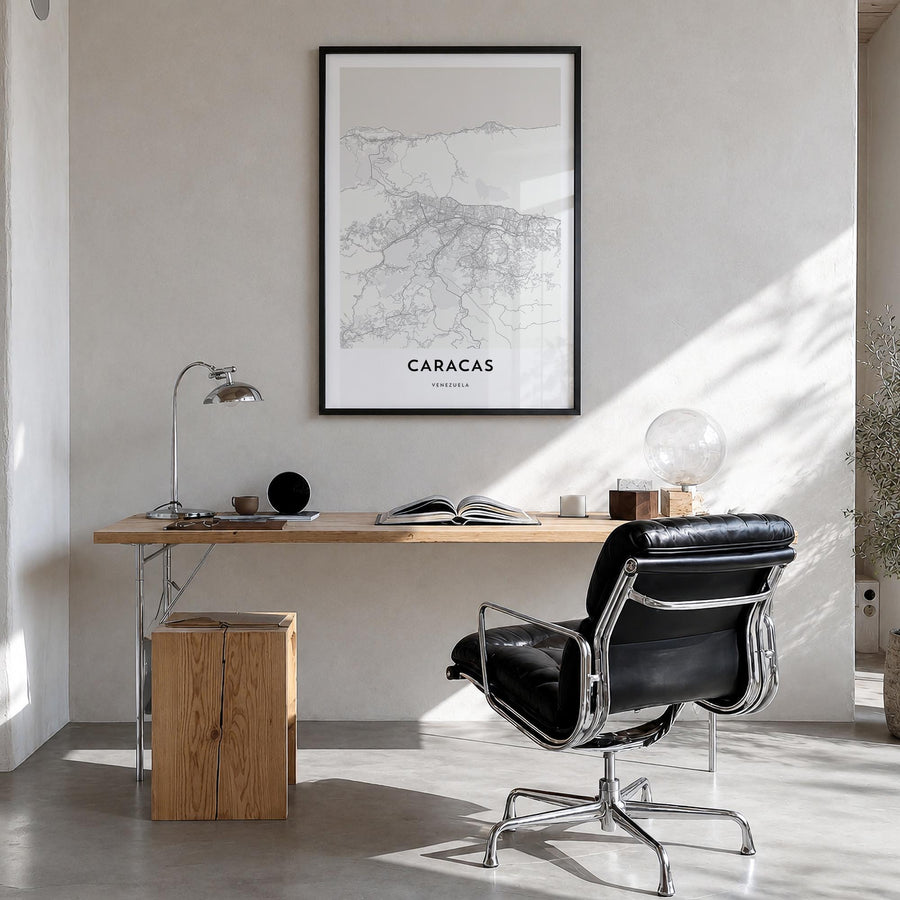 Caracas black & white map poster of Venezuela – vertical wall art in black wood frame, hanging on wall