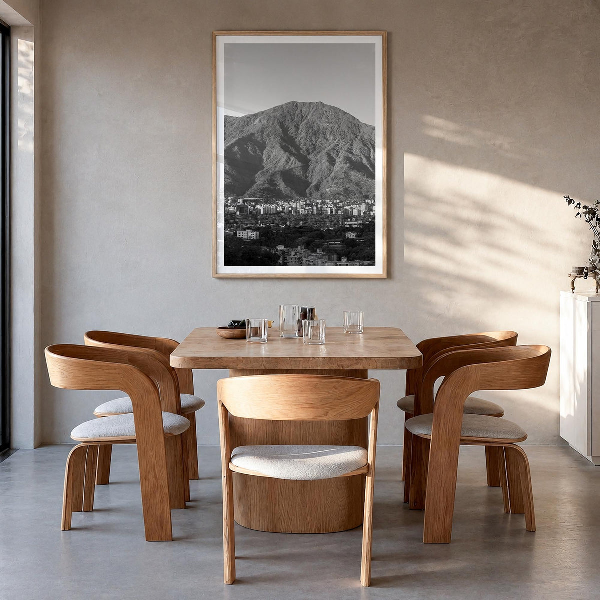 Caracas black & white photo poster of Venezuela – vertical wall art in natural wood frame with white border, hanging on wall
