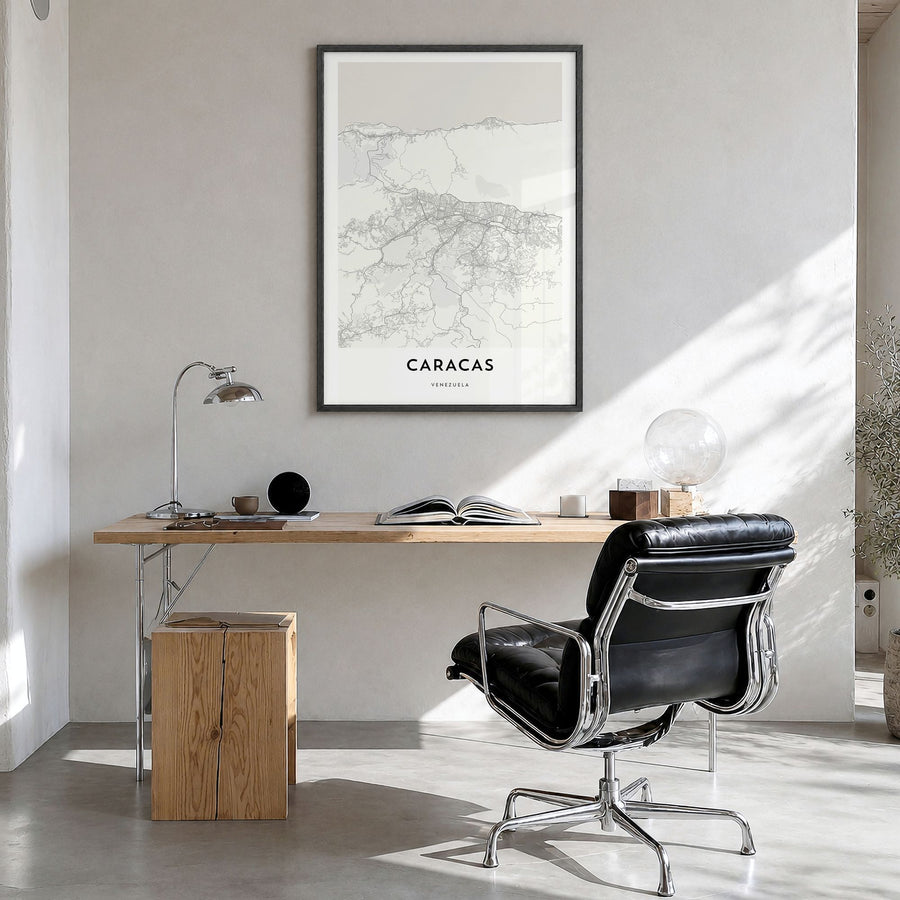 Caracas Map Poster in a black wood frame, hanging in a bright home office