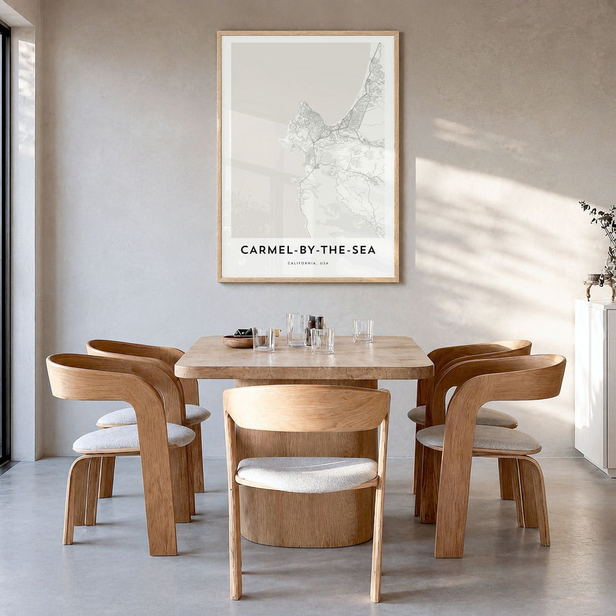 Carmel-by-the-Sea Map Poster in a natural wood frame, hanging in a dining room