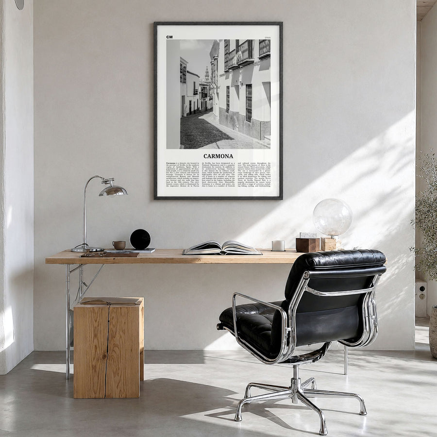Carmona Newspaper Poster in a black wood frame, hanging in a bright home office
