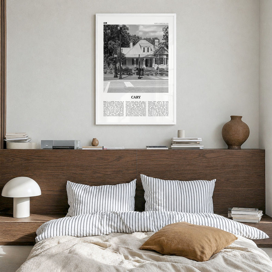 Cary Newspaper Poster in a white wood frame, hanging in a bedroom
