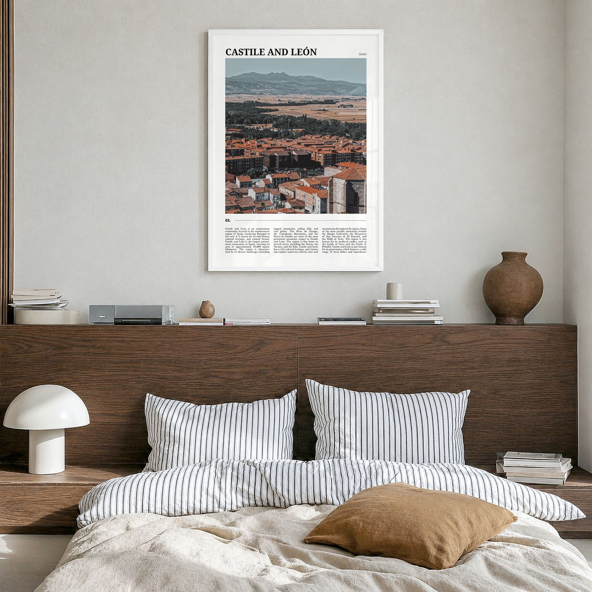 Castile and León Travel Poster in a white wood frame, hanging in a bedroom