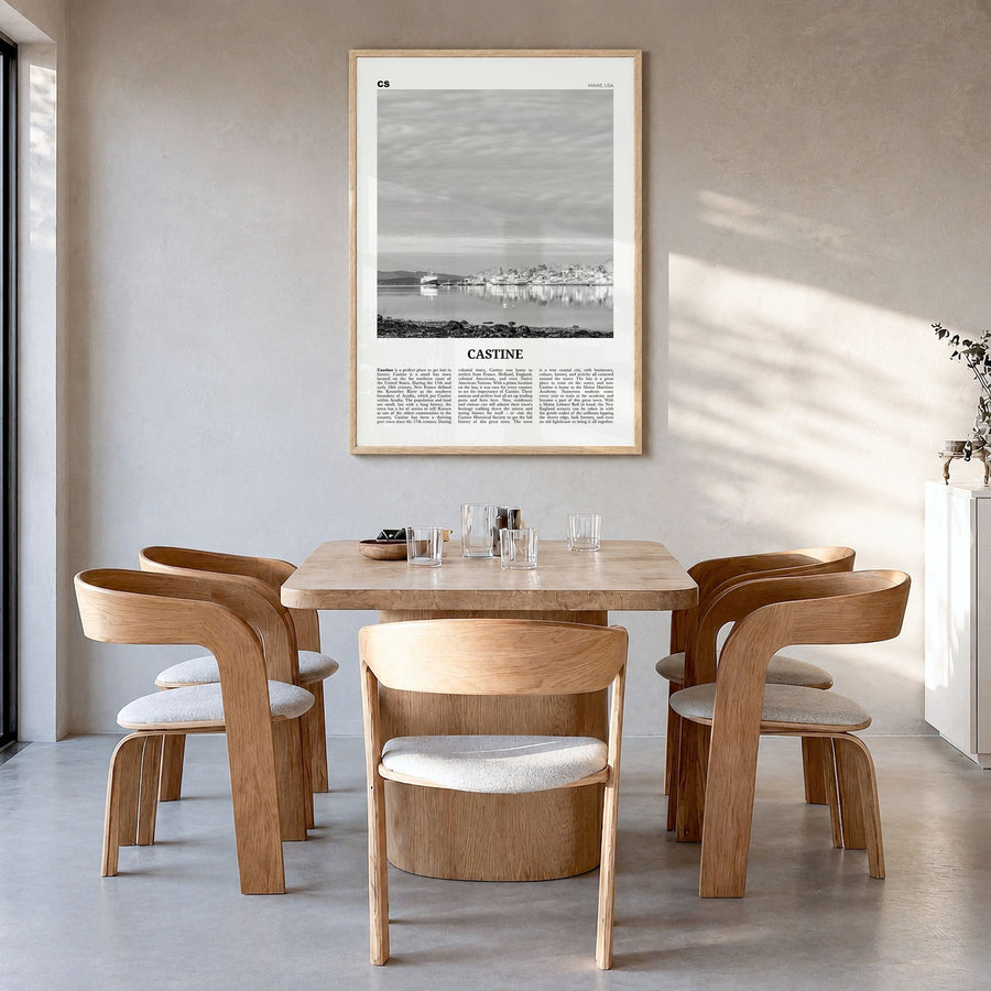 Castine Newspaper Poster in a natural wood frame, hanging in a dining room