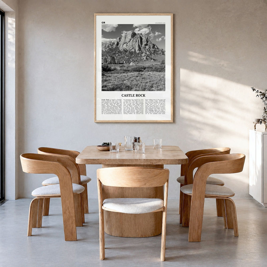 Castle Rock Newspaper Poster in a natural wood frame, hanging in a dining room